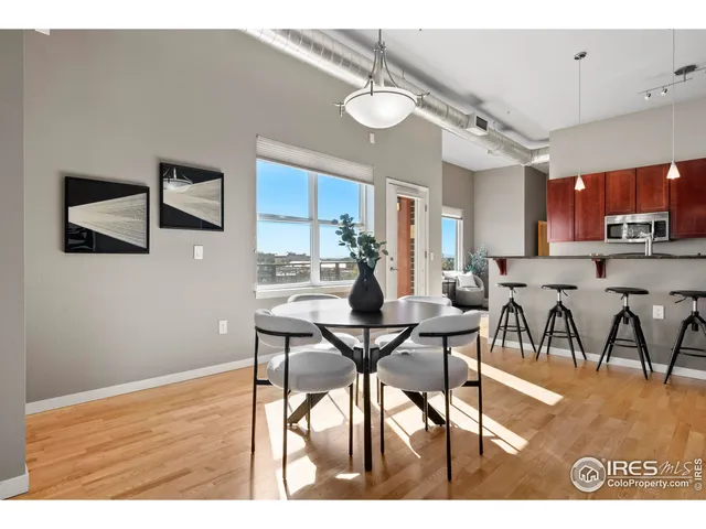 a view of a dining room with furniture and a kitchen