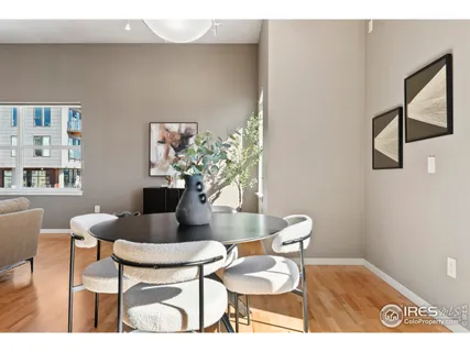 a dining room with furniture and wooden floor