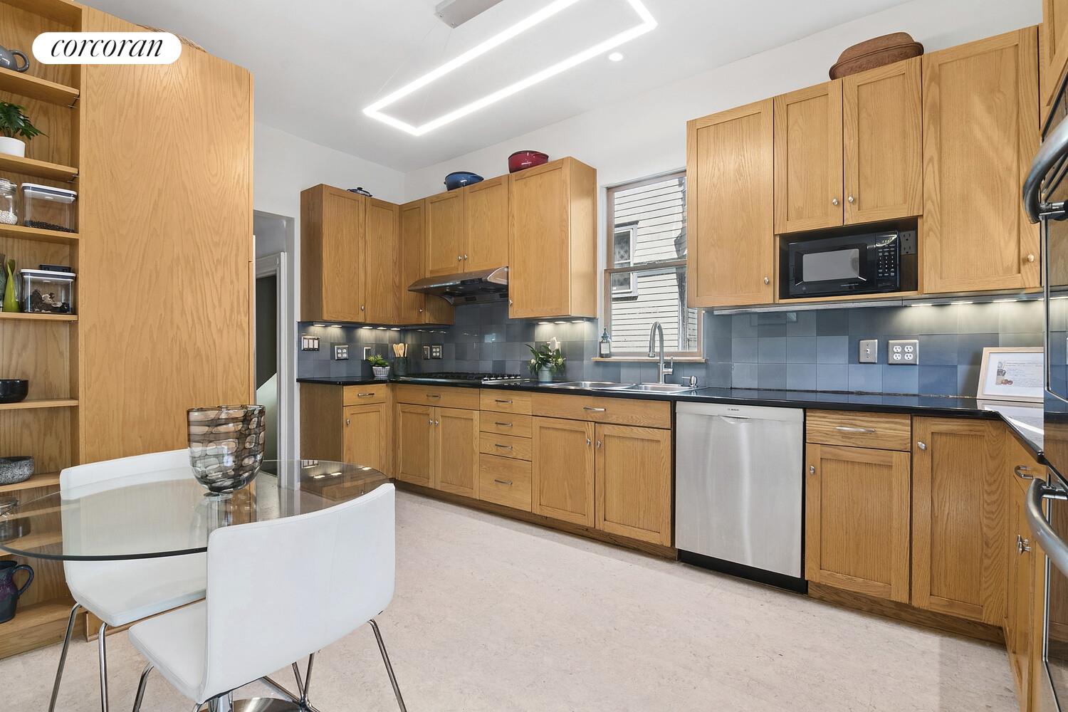 739 Argyle Road Brooklyn, NY 11230 - Photo 9 of 27 a kitchen with stainless steel appliances granite countertop a sink a stove a microwave a refrigerator and cabinets