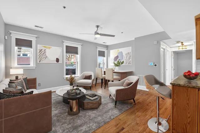 a living room with furniture and wooden floor