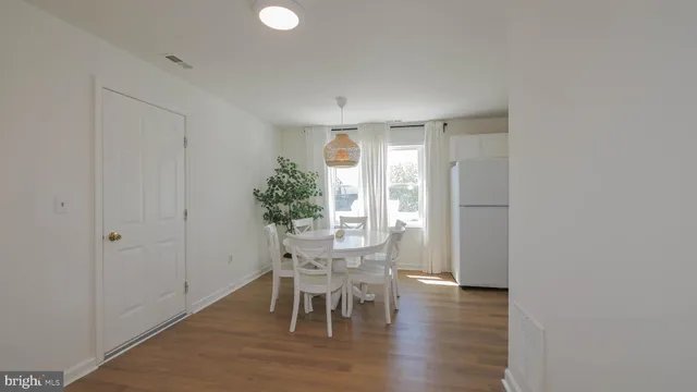 a dining room with furniture a window and kitchen view