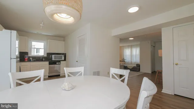 a kitchen with stainless steel appliances granite countertop a refrigerator a stove and white cabinets