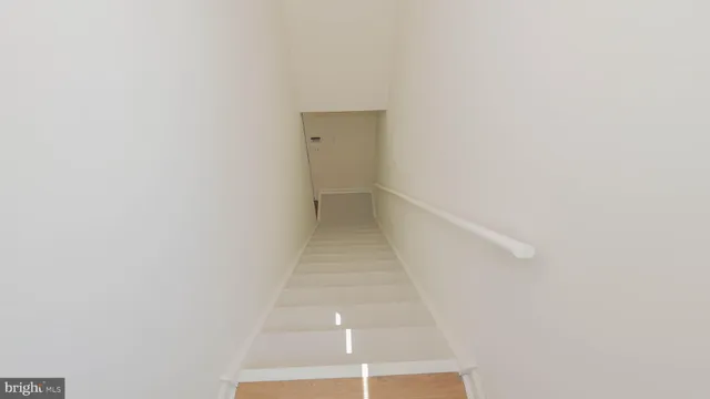 a bedroom with a bed and a lamp on the dresser