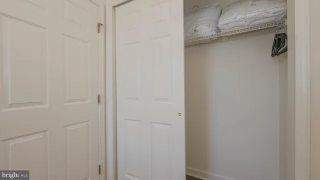 a view of a bedroom with furniture and windows