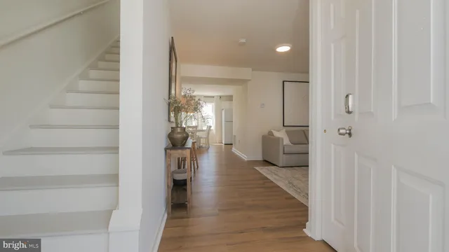 a living room with furniture a flat screen tv and a large window