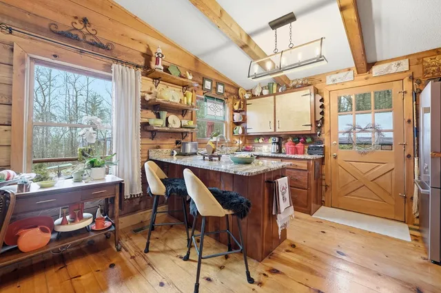 a kitchen with a stove and a wooden cabinets