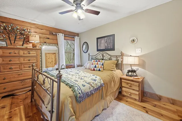 a bathroom with a granite countertop sink a toilet and mirror