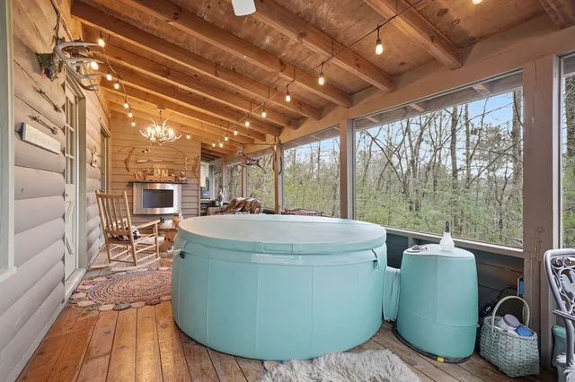 a front view of a house with a garden and tree