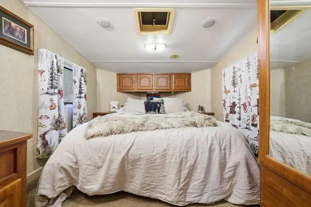 a dining room with stainless steel appliances granite countertop a kitchen island a stove a refrigerator and cabinets with wooden floor