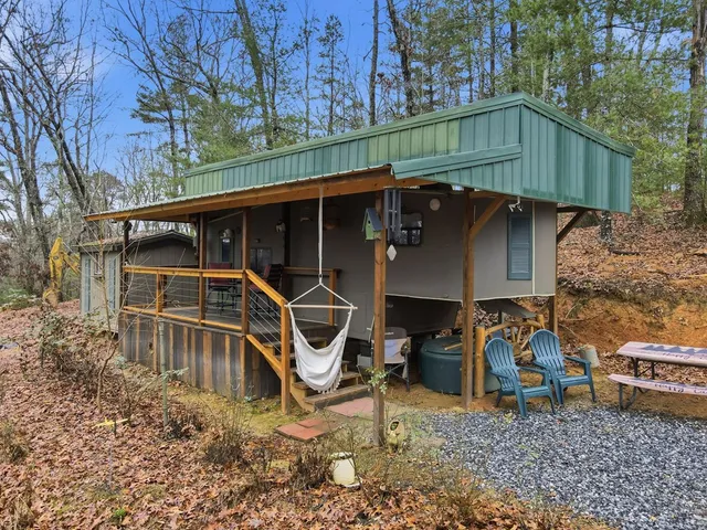 a view of a backyard with a table and chairs under an umbrella