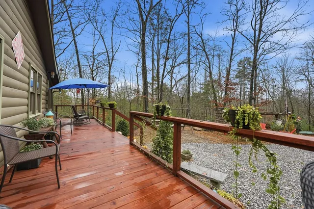 a view of a balcony with chairs and wooden floor