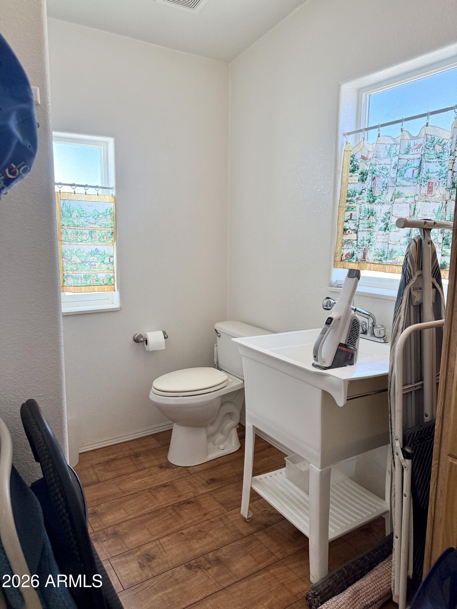 7750 East Broadway Road, Unit 197 Mesa, AZ 85208 - Photo 18 of 38 a bathroom with a toilet a sink and a window