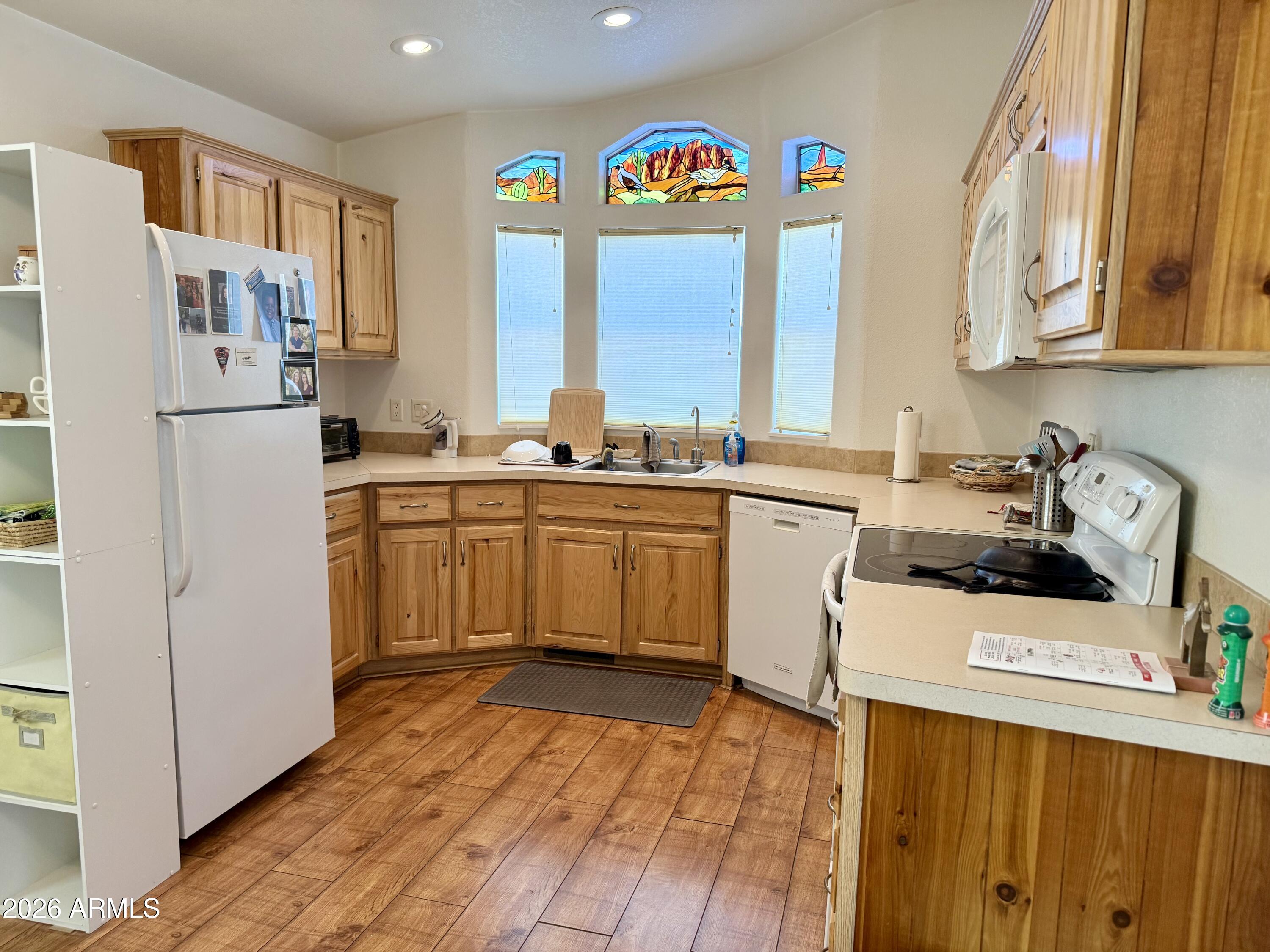 7750 East Broadway Road, Unit 197 Mesa, AZ 85208 - Photo 2 of 38 a kitchen with stainless steel appliances a sink a stove a refrigerator cabinets and a window