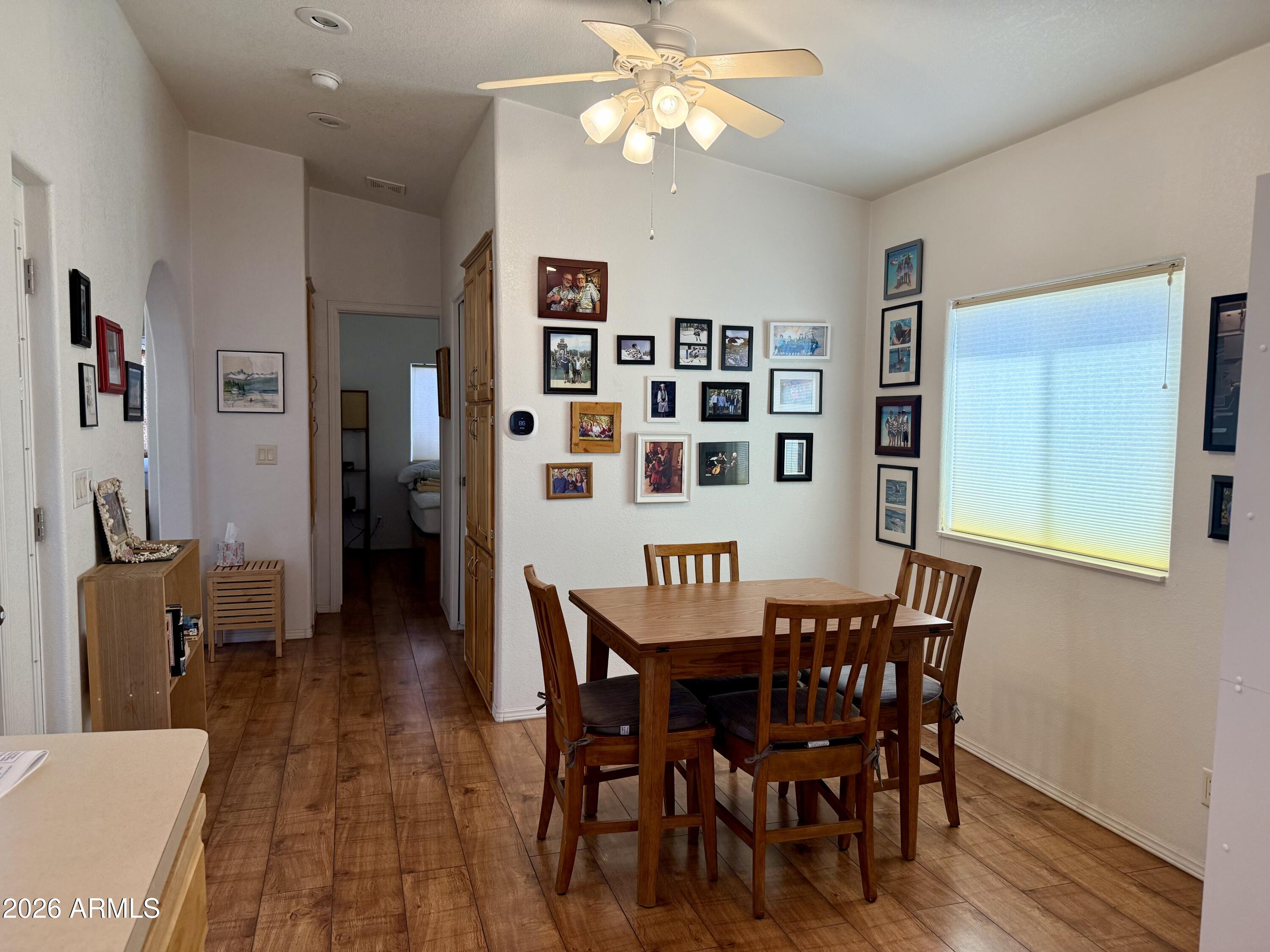 7750 East Broadway Road, Unit 197 Mesa, AZ 85208 - Photo 3 of 38 a view of a dining room with furniture and wooden floor