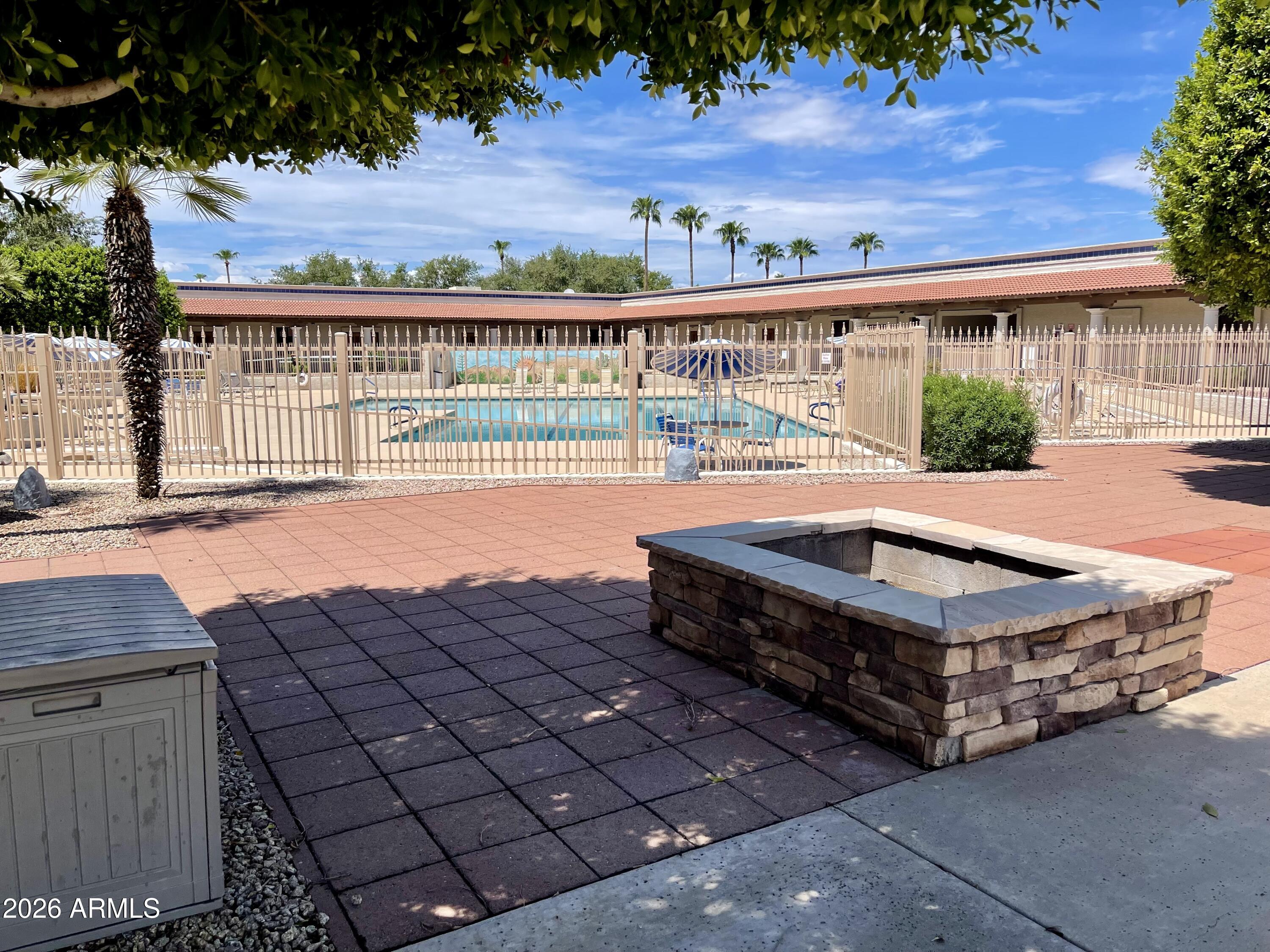 7750 East Broadway Road, Unit 197 Mesa, AZ 85208 - Photo 37 of 38 a view of swimming pool with seating space and wooden fence