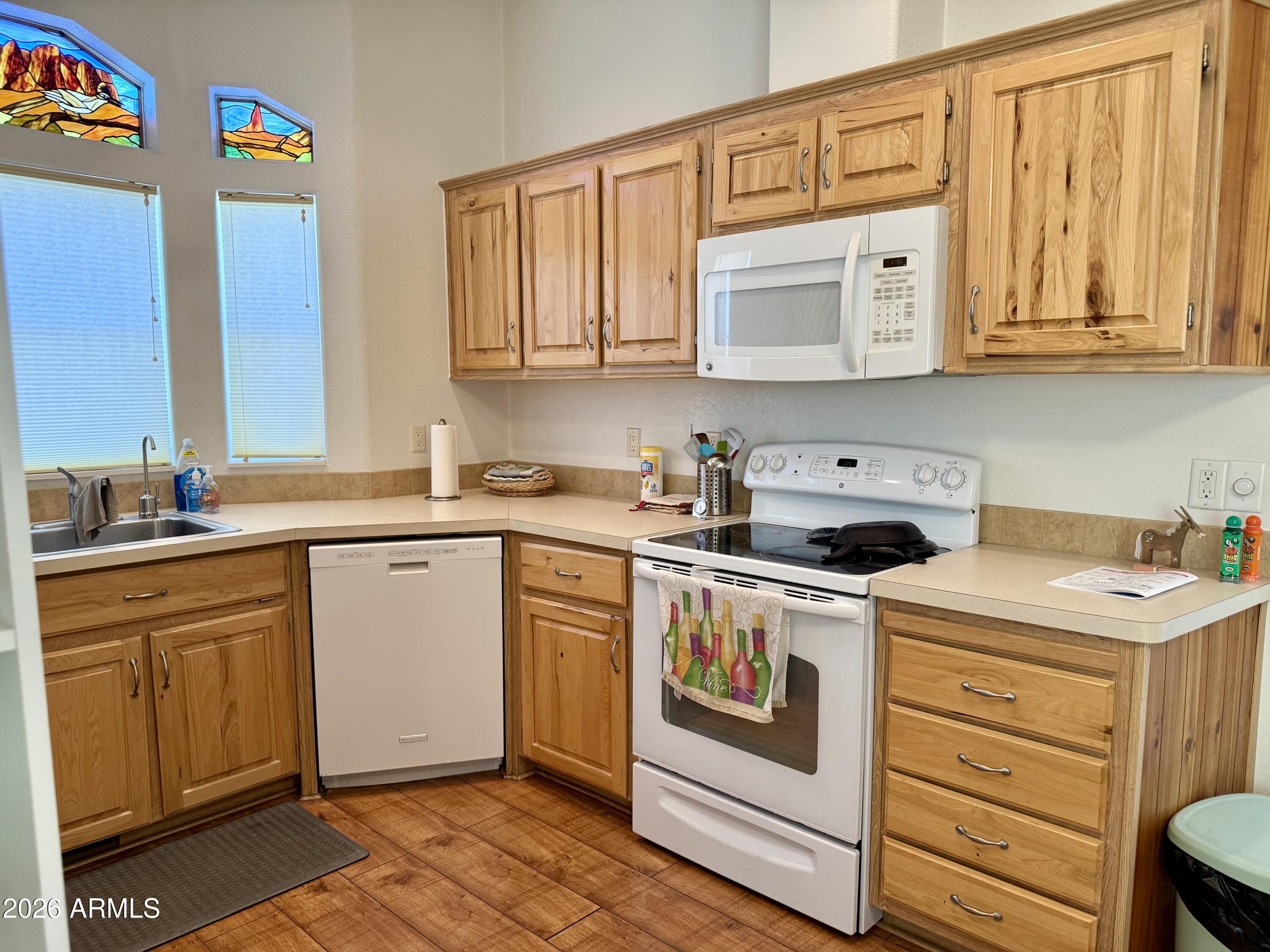 7750 East Broadway Road, Unit 197 Mesa, AZ 85208 - Photo 6 of 38 a kitchen with stainless steel appliances granite countertop a sink and cabinets