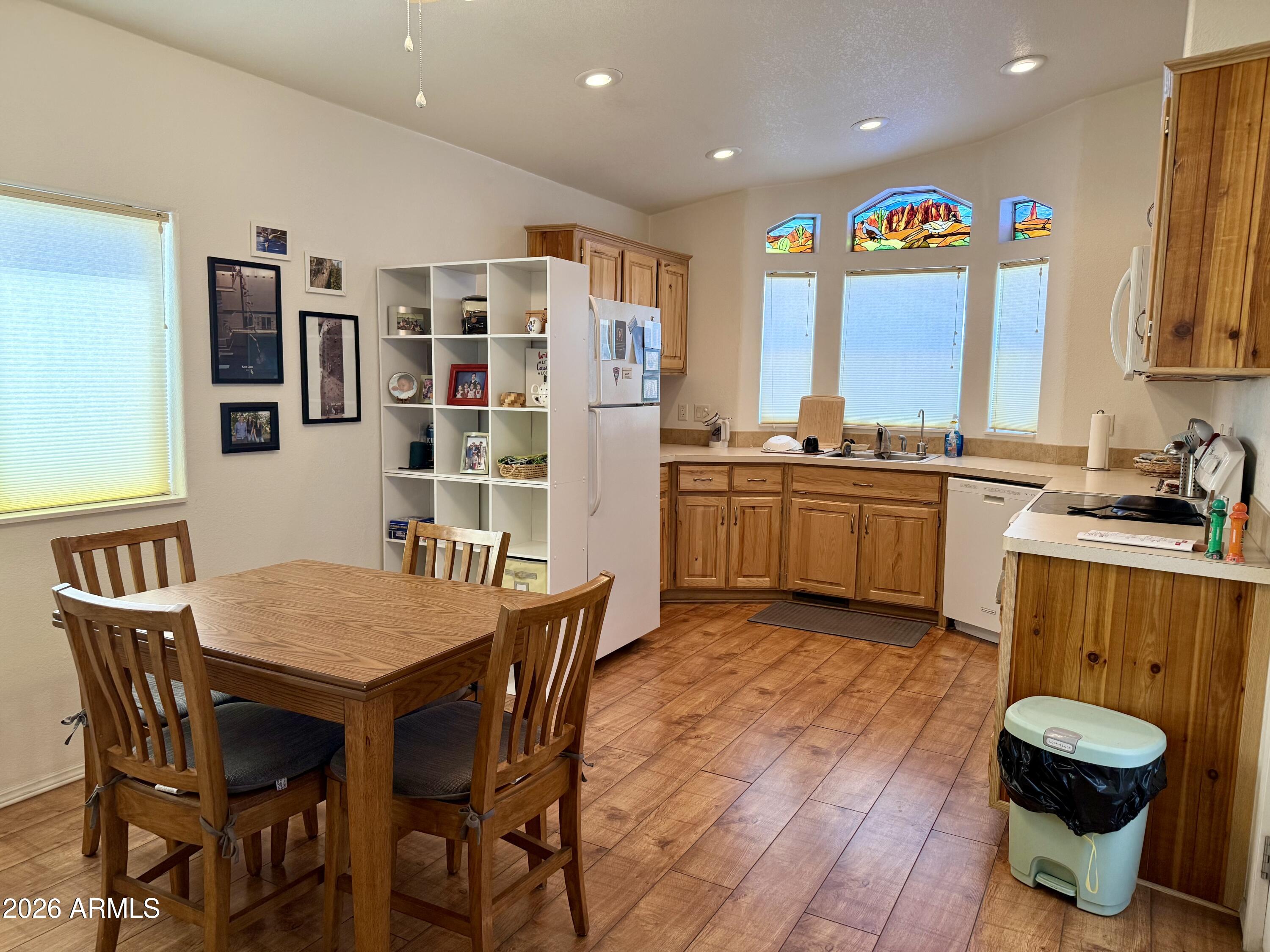 7750 East Broadway Road, Unit 197 Mesa, AZ 85208 - Photo 8 of 38 a view of a dining room with furniture window and wooden floor