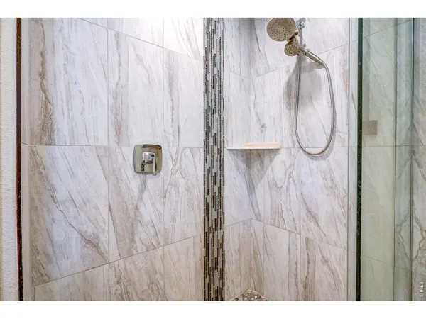 a view of a backyard with floor to ceiling window and wooden fence