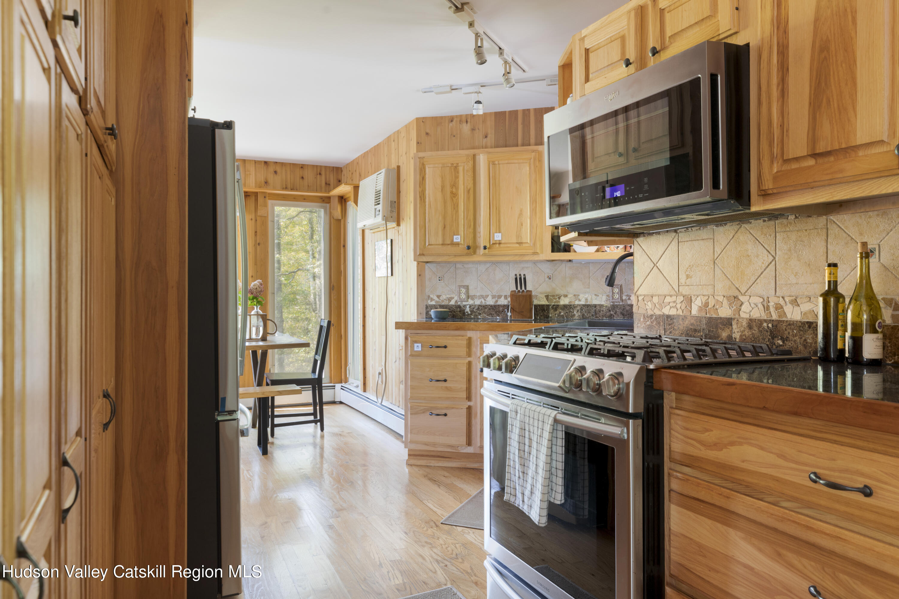 94 Sparkling Ridge Road New Paltz, NY 12561 - Photo 16 of 35 a kitchen with stainless steel appliances granite countertop a stove top oven a sink and a refrigerator