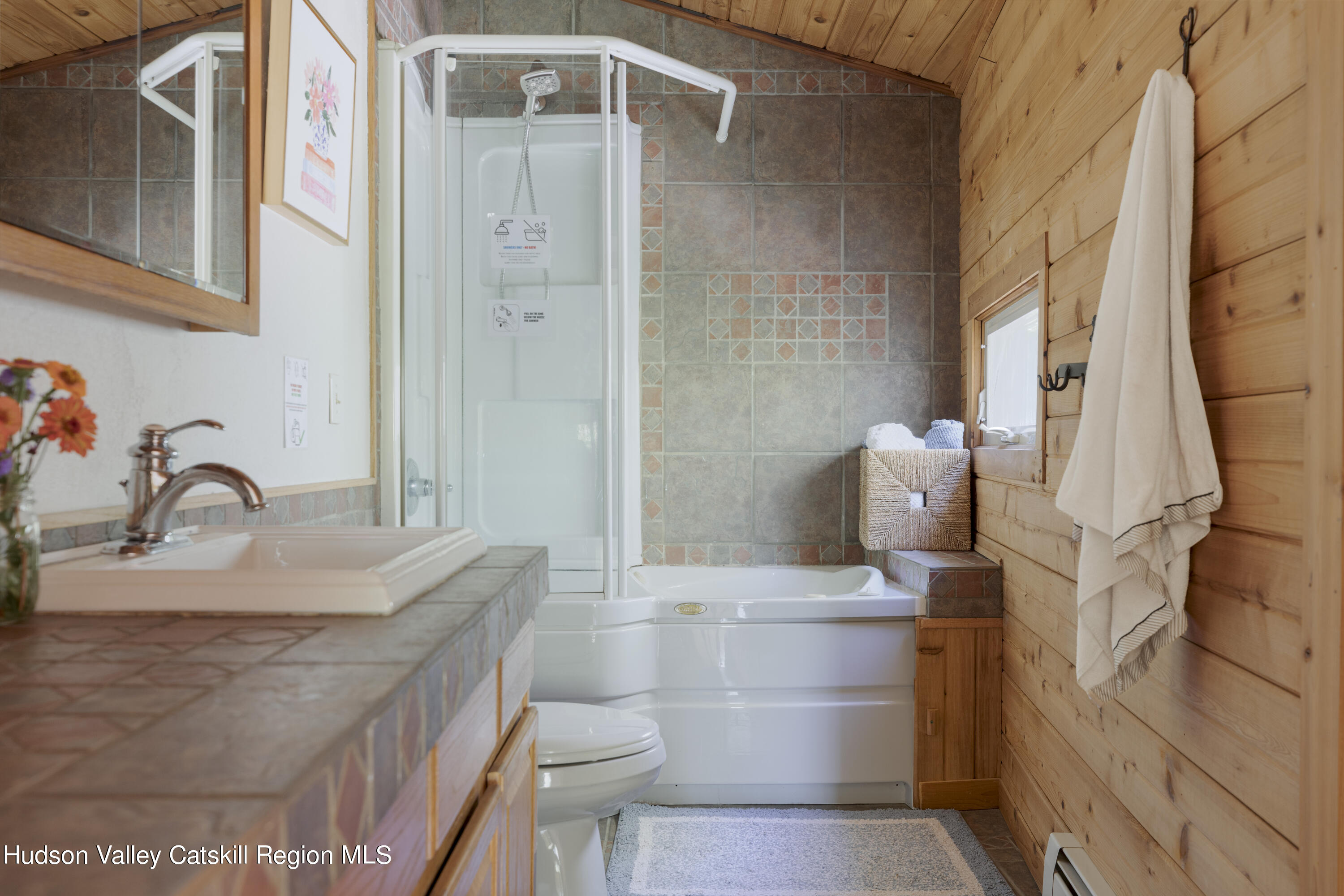 94 Sparkling Ridge Road New Paltz, NY 12561 - Photo 19 of 35 a bathroom with a granite countertop sink a toilet and shower