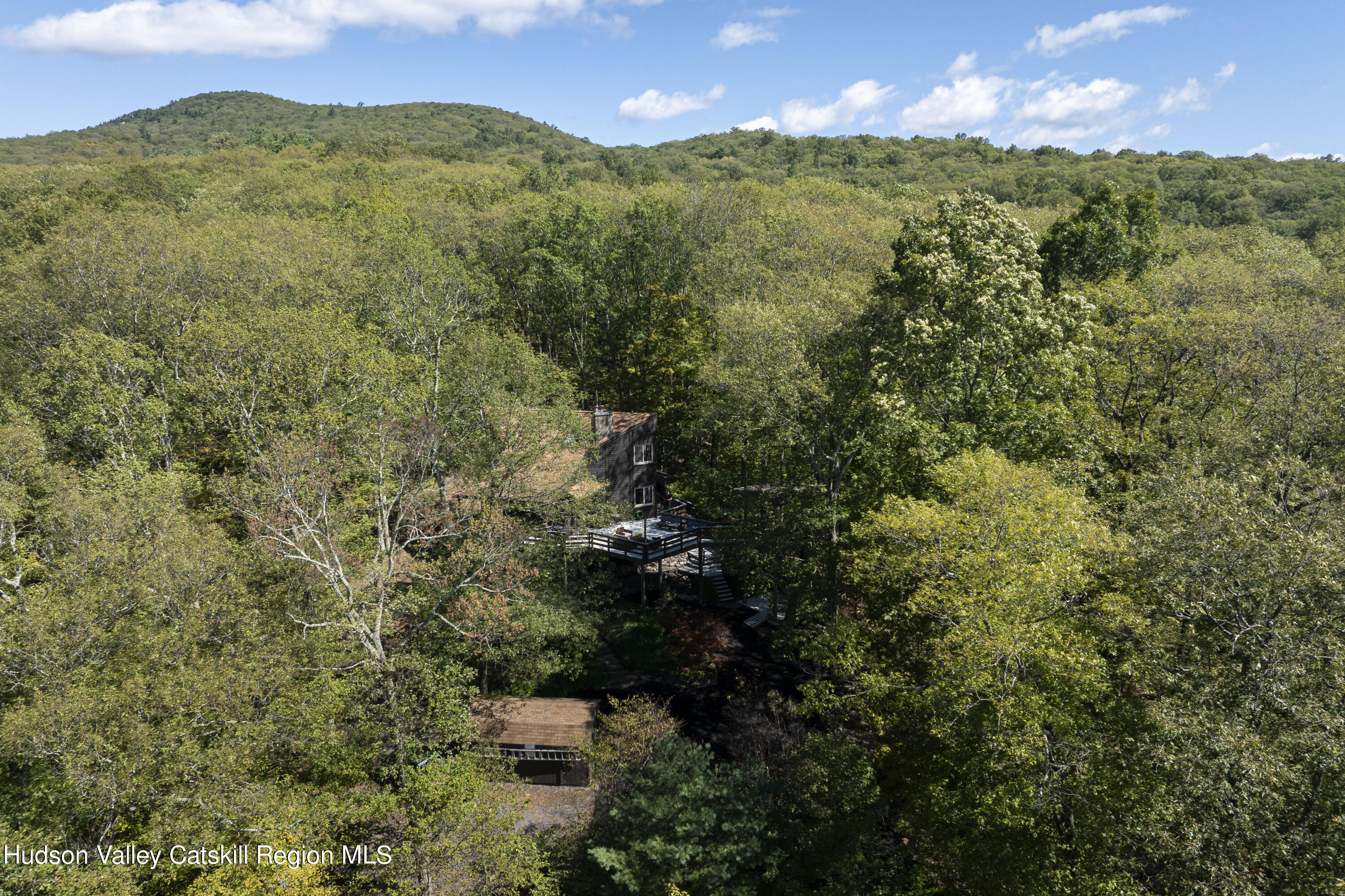 94 Sparkling Ridge Road New Paltz, NY 12561 - Photo 34 of 35 a view of a city with lush green forest
