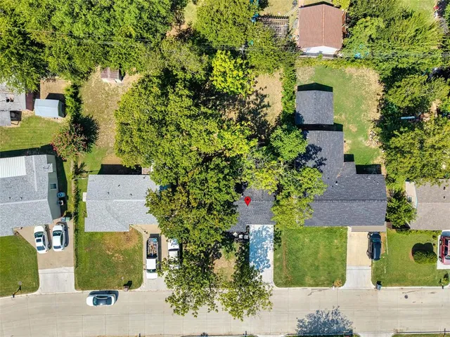 an aerial view of a house with a yard and garden space