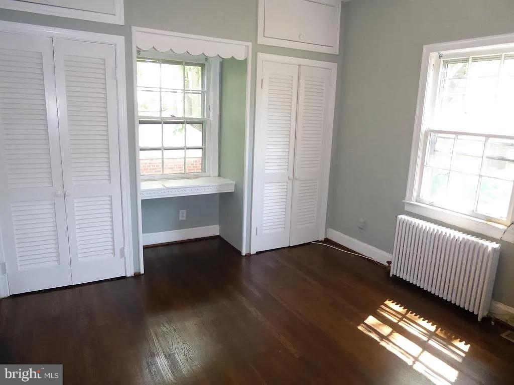 4344 Ellicott Street Northwest Washington, DC 20016 - Photo 13 of 25 an empty room with wooden floor and windows