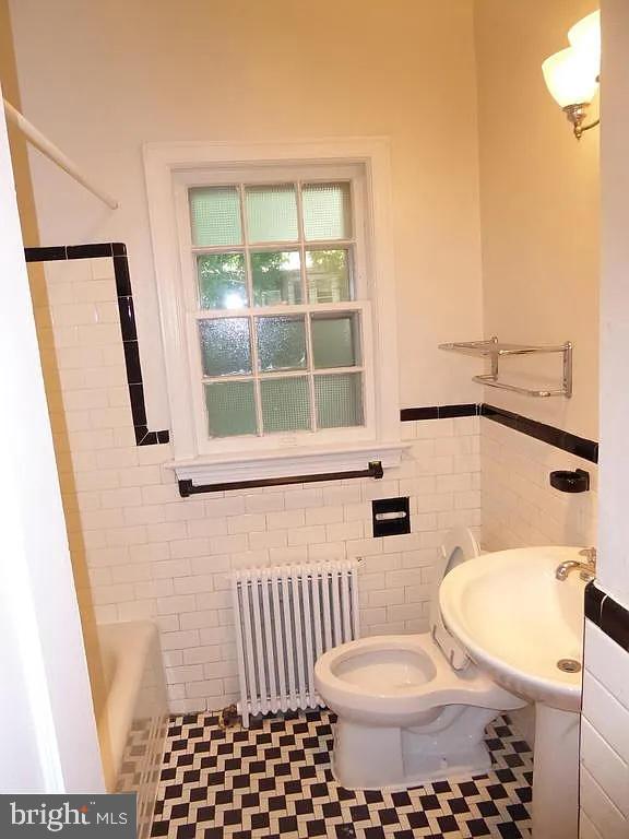 4344 Ellicott Street Northwest Washington, DC 20016 - Photo 15 of 25 a bathroom with a toilet a sink and a window