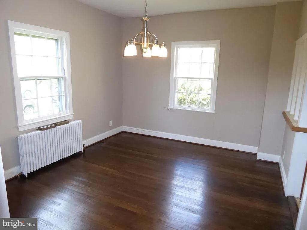 4344 Ellicott Street Northwest Washington, DC 20016 - Photo 16 of 25 an empty room with wooden floor and windows