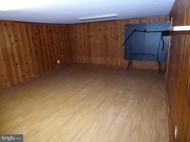 a view of a room with wooden walls