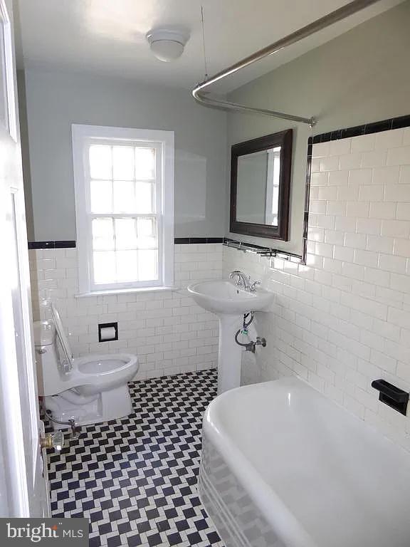 4344 Ellicott Street Northwest Washington, DC 20016 - Photo 6 of 25 a bathroom with a sink a toilet and window