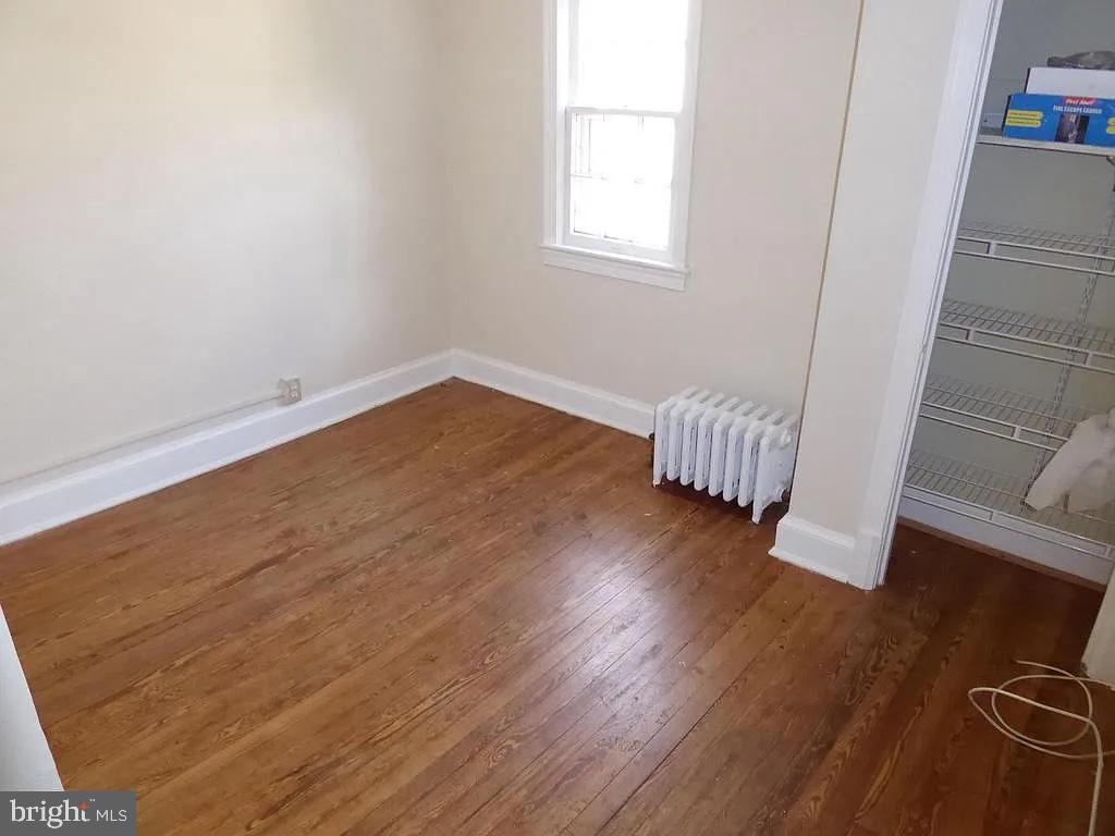 4344 Ellicott Street Northwest Washington, DC 20016 - Photo 7 of 25 an empty room with wooden floor and windows