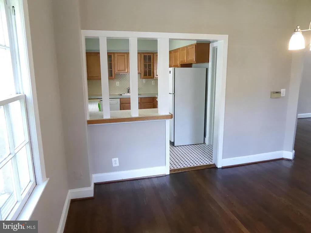 4344 Ellicott Street Northwest Washington, DC 20016 - Photo 10 of 25 an empty room with wooden floor and windows