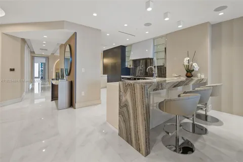 a view of kitchen with stainless steel appliances furniture refrigerator and wooden floor
