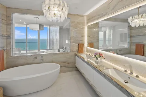 a bathroom with a sink vanity mirror and toilet