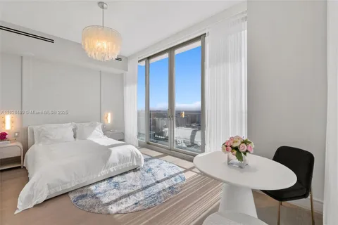 a bathroom with a granite countertop tub sink and mirror