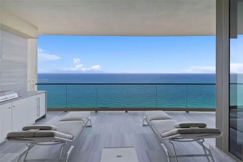 a view of swimming pool with sitting area