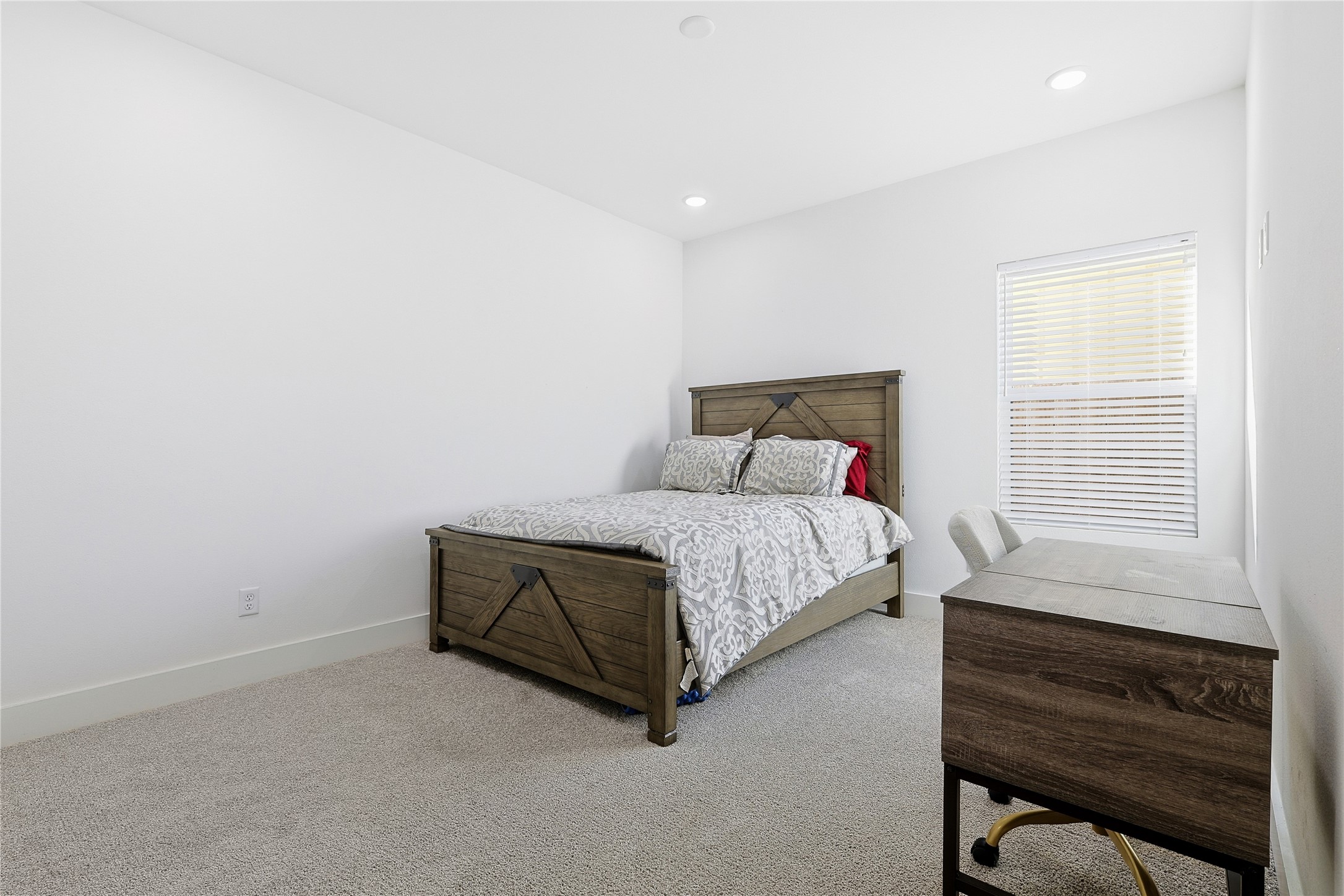 107 West Whitney Street, Unit C Houston, TX 77018 - Photo 19 of 27 a bed sitting in a bedroom next to a window