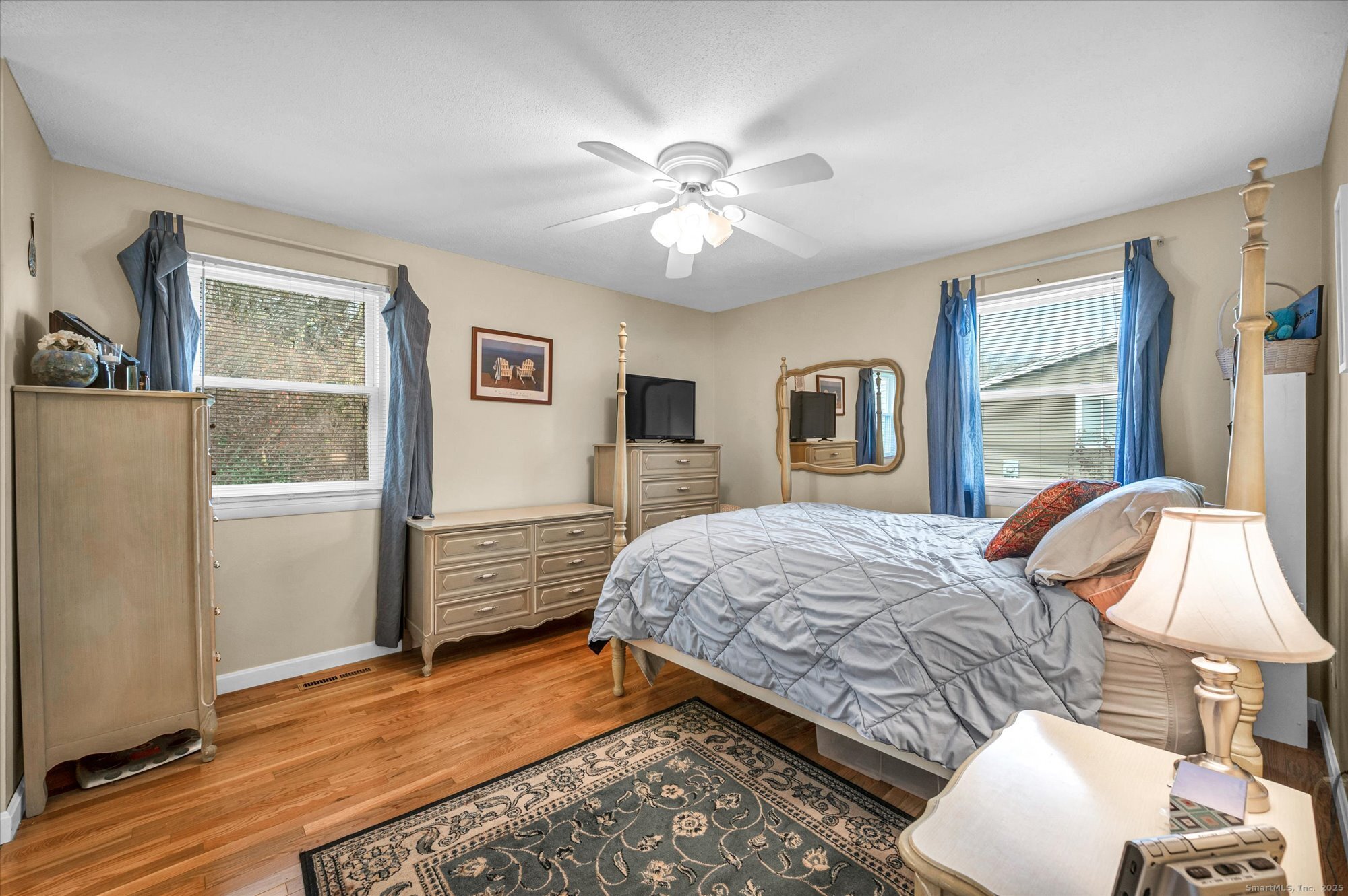 491 Long Hill Road Middletown, CT 06457 - Photo 13 of 27 a bedroom with a bed and wooden floor