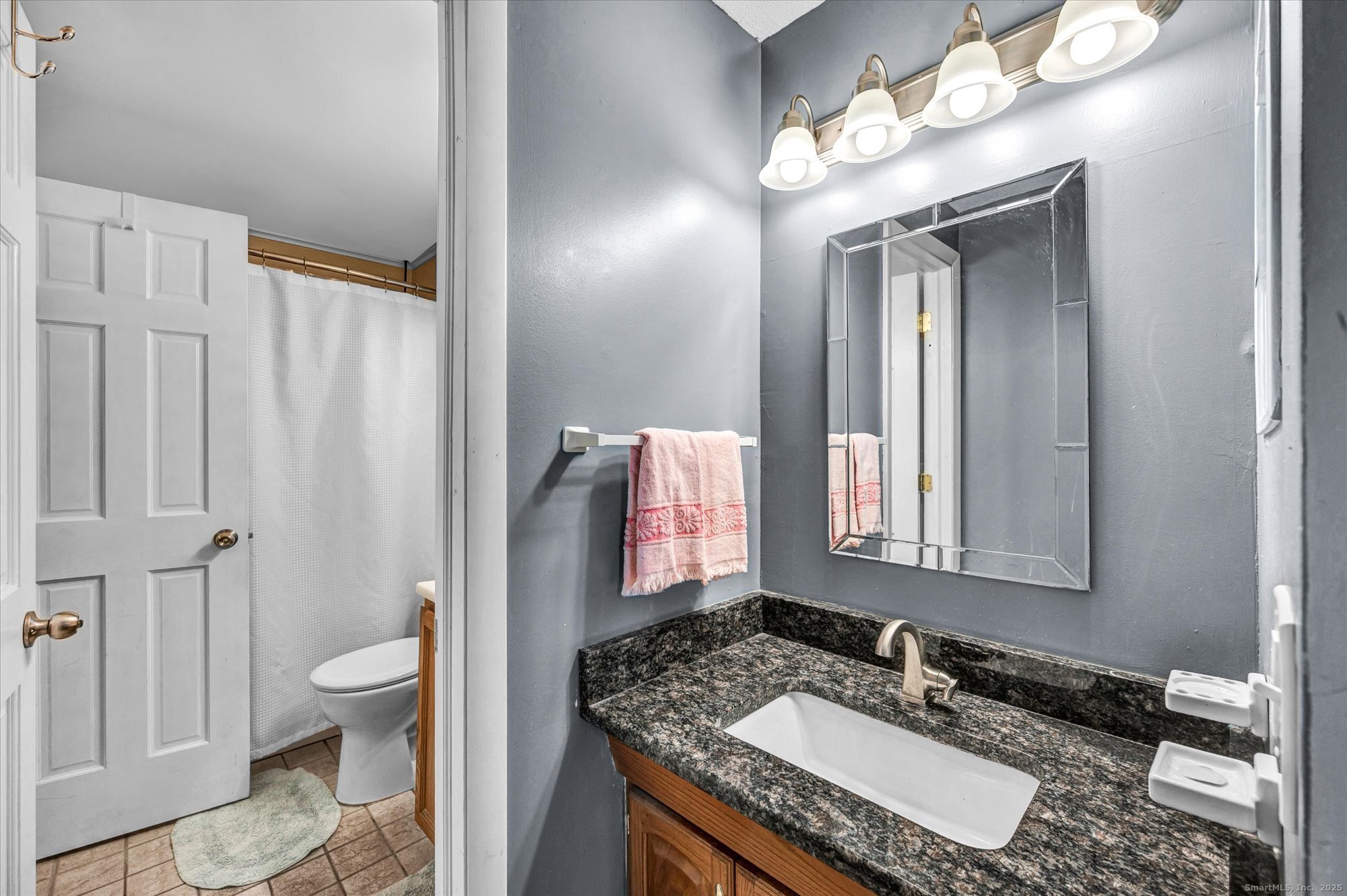 491 Long Hill Road Middletown, CT 06457 - Photo 14 of 27 a bathroom with a granite countertop sink and a mirror