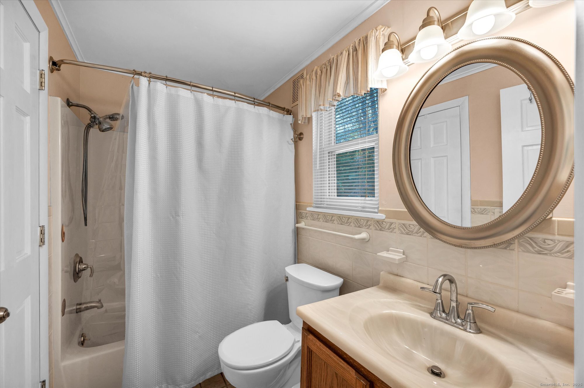 491 Long Hill Road Middletown, CT 06457 - Photo 15 of 27 a bathroom with a sink a toilet and a mirror