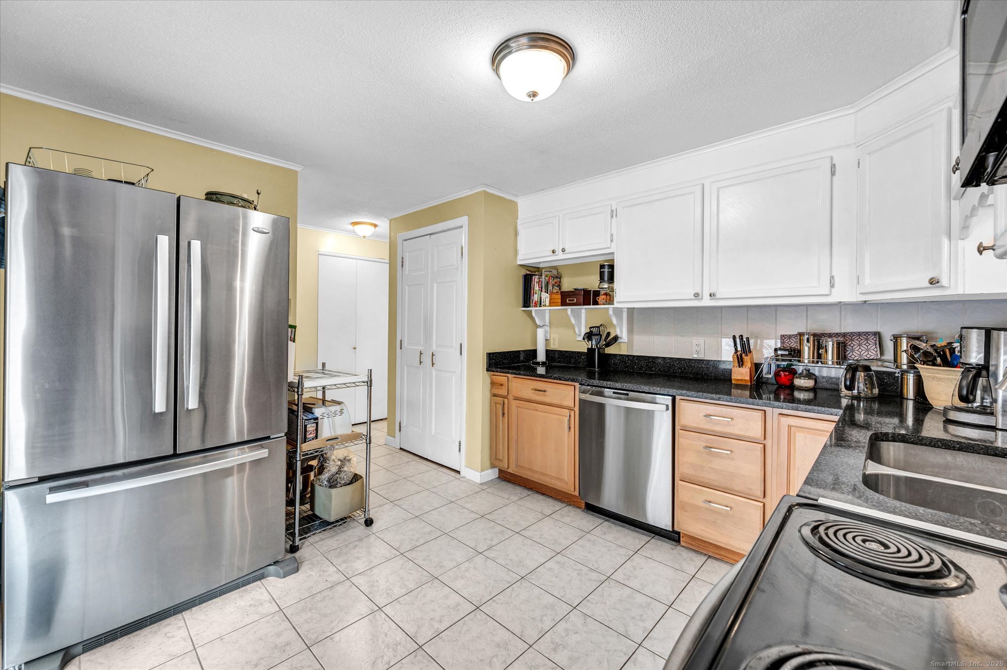491 Long Hill Road Middletown, CT 06457 - Photo 10 of 27 a kitchen with stainless steel appliances a refrigerator sink and white cabinets