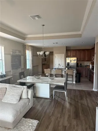 a kitchen with a sink and chairs