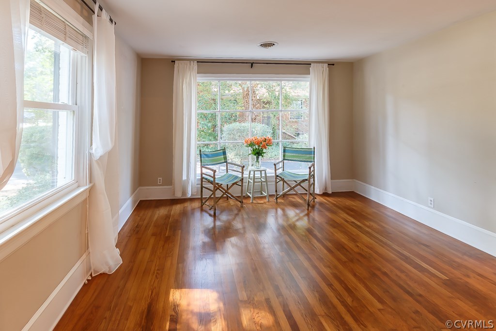 Family room with large window and wood floors.
