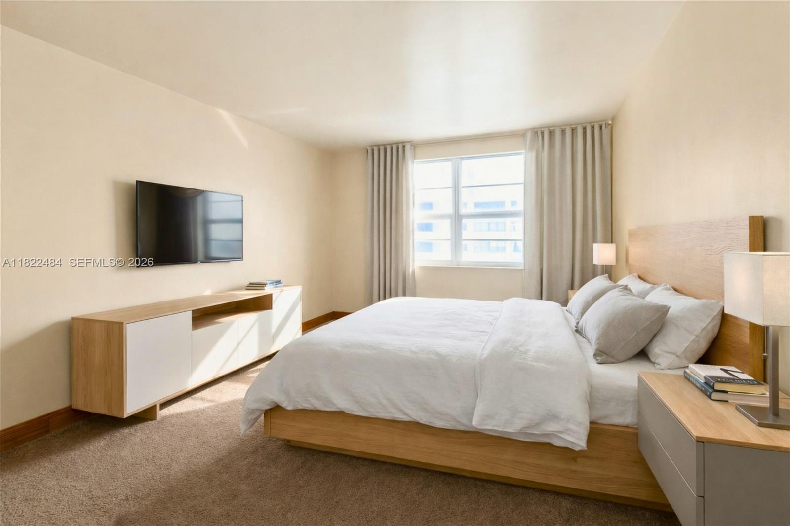 100 Lincoln Road, Unit 811 Miami Beach, FL 33139 - Photo 12 of 29 a bedroom with a bed and flat screen tv
