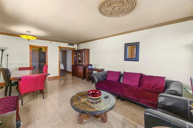 a living room with furniture a rug and a wall painting