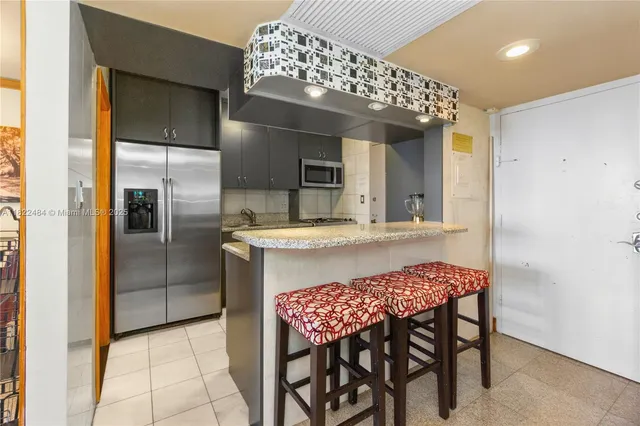 a kitchen with a table and chairs in it