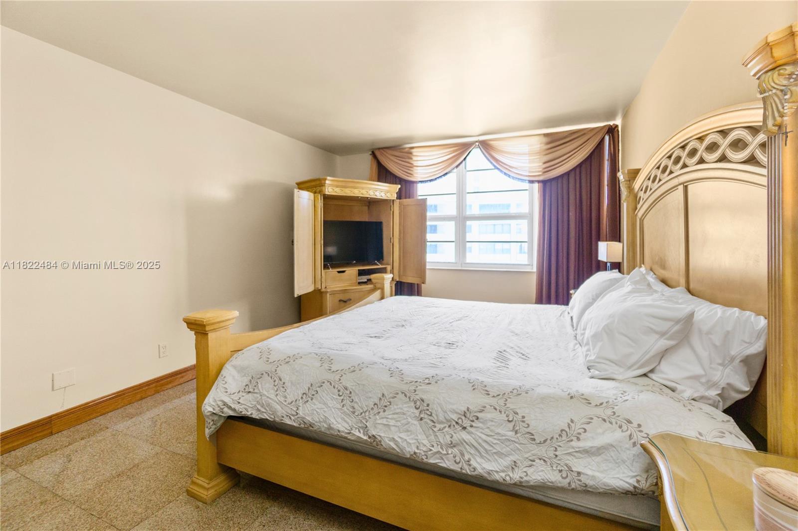 100 Lincoln Road, Unit 811 Miami Beach, FL 33139 - Photo 23 of 36 a bedroom with a bed and dresser with mirror