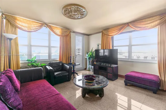 a living room with furniture and a large window