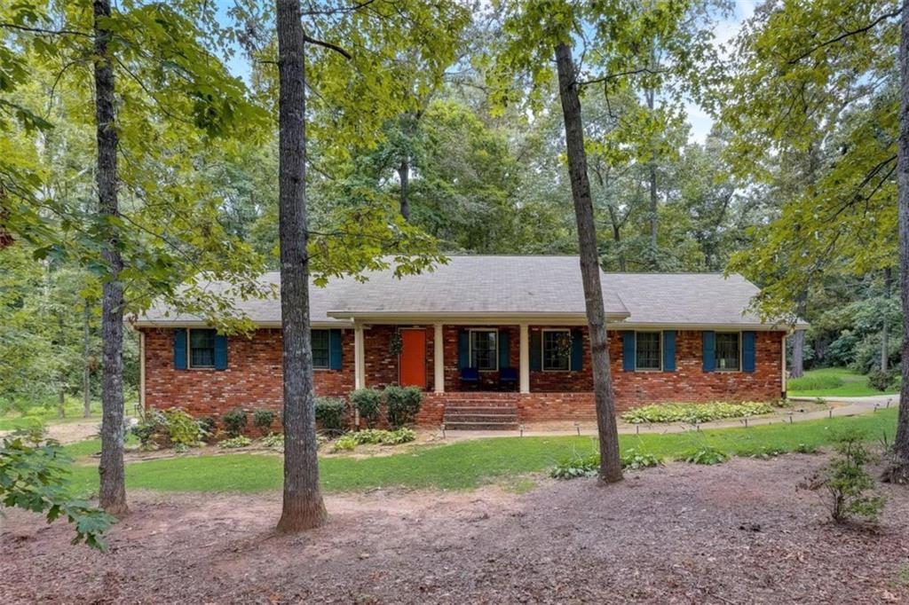 4112 Cimarron Drive Clarkston, GA 30021 - Photo 1 of 1 a front view of a house with garden